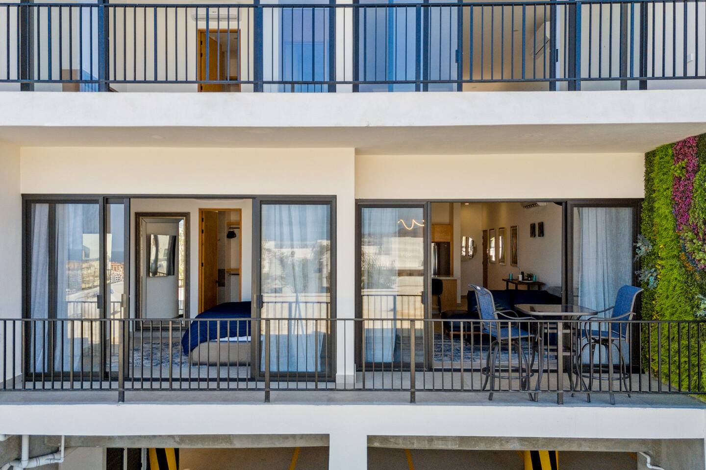 Relax on the outdoor double-wide balcony, featuring a stunning nature wall, a high-top table, and comfy chairs. Perfect for enjoying al fresco dining or serene views during your Mexico escape.