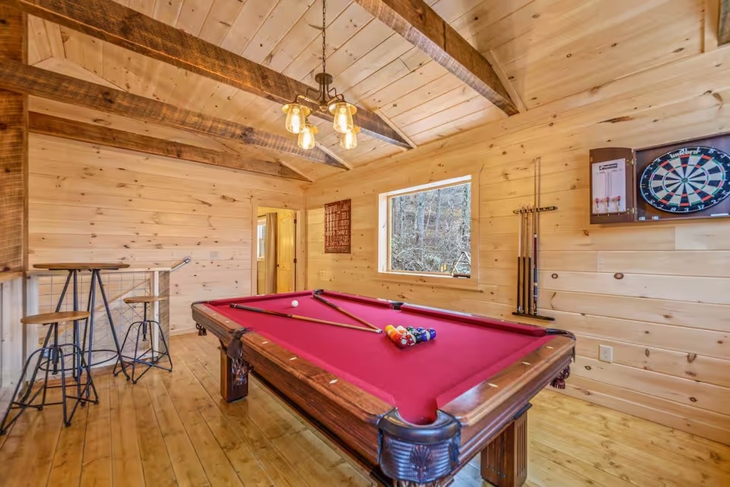Kids and adults alike will love the game room at Bear Paws Cabin. A full-size pool table, dartboard, and large windows overlooking the Smoky Mountain forest make this the go-to spot on rainy days &mdash; or any time the family wants to compete without leaving.