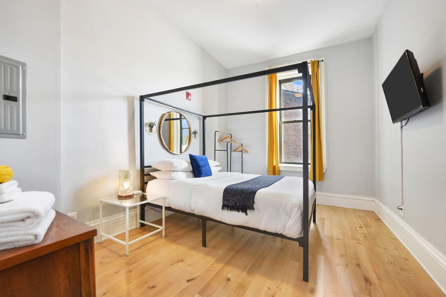 Cozy queen-sized bed with a unique frame and a TV for laid-back movie nights.