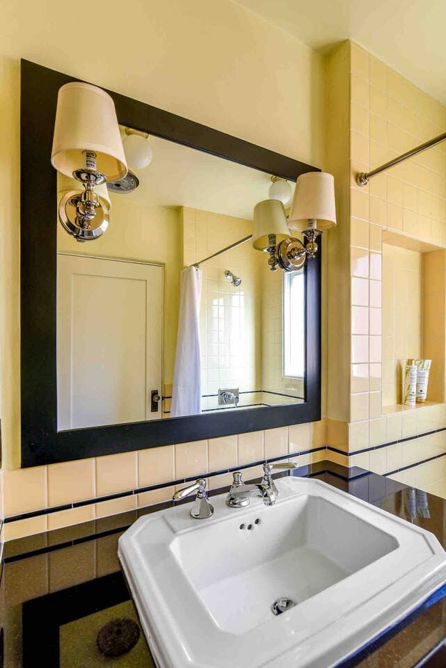 Sink cabinet with large vanity mirror and storage.  