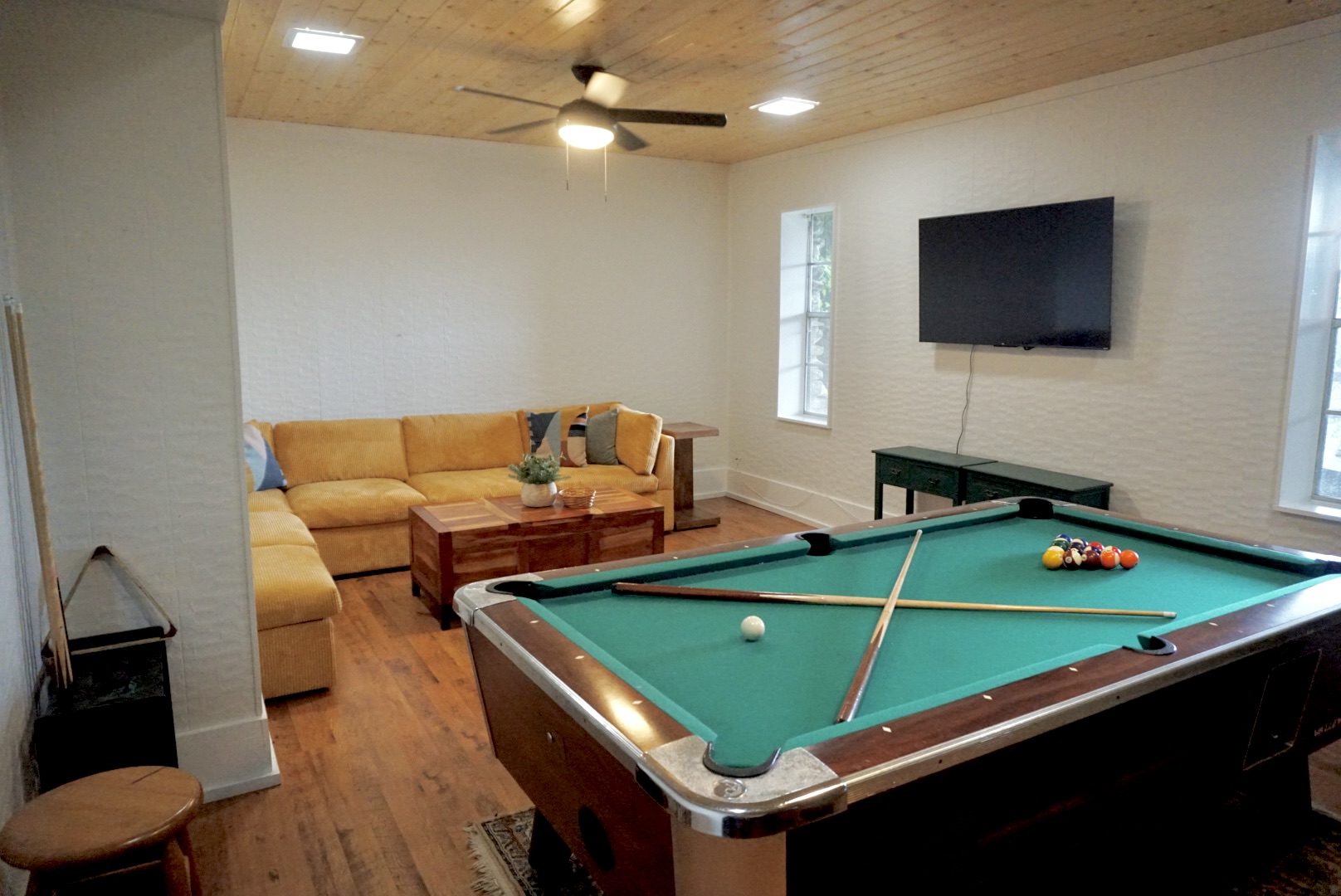 Play pool and unwind in this vibrant space with a comfy sectional and TV!
