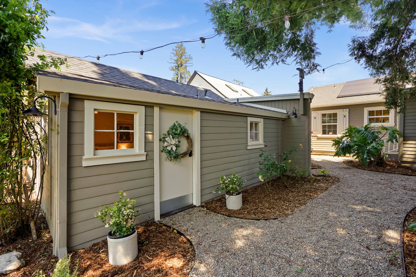 Charming private studio entrance with stylish outdoor seating, peaceful surroundings, and a welcoming Napa retreat feel.