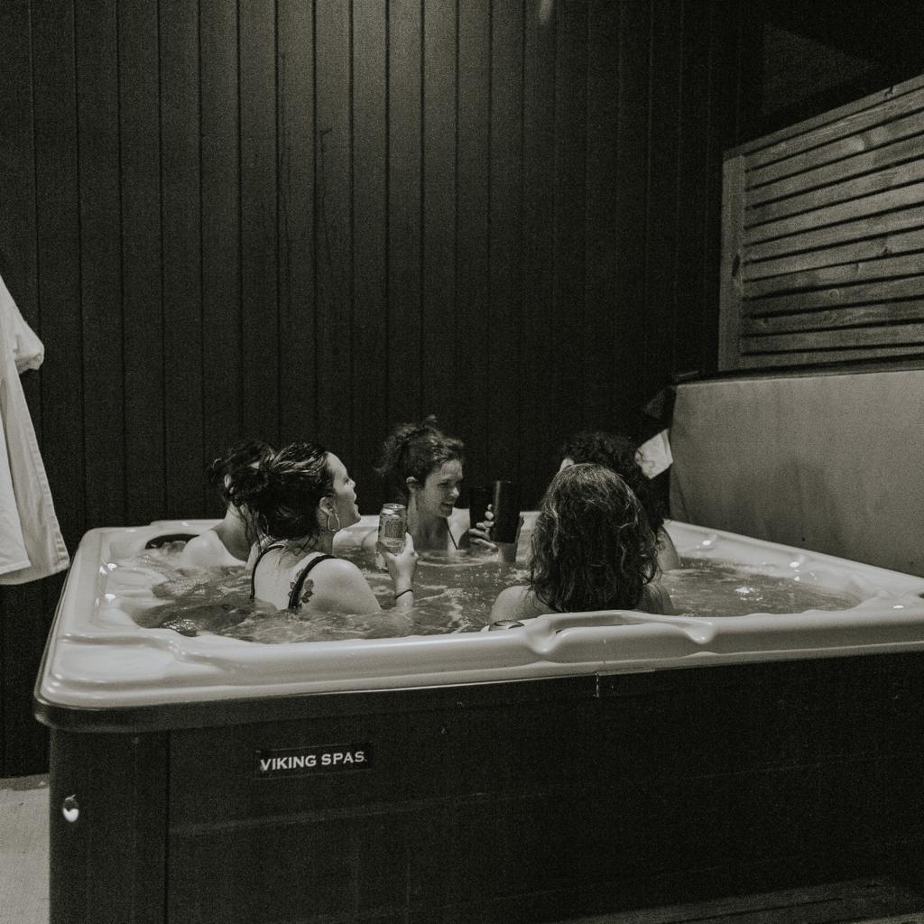 Glass House hot tub nights—soak, sip, and stay awhile 🖤✨