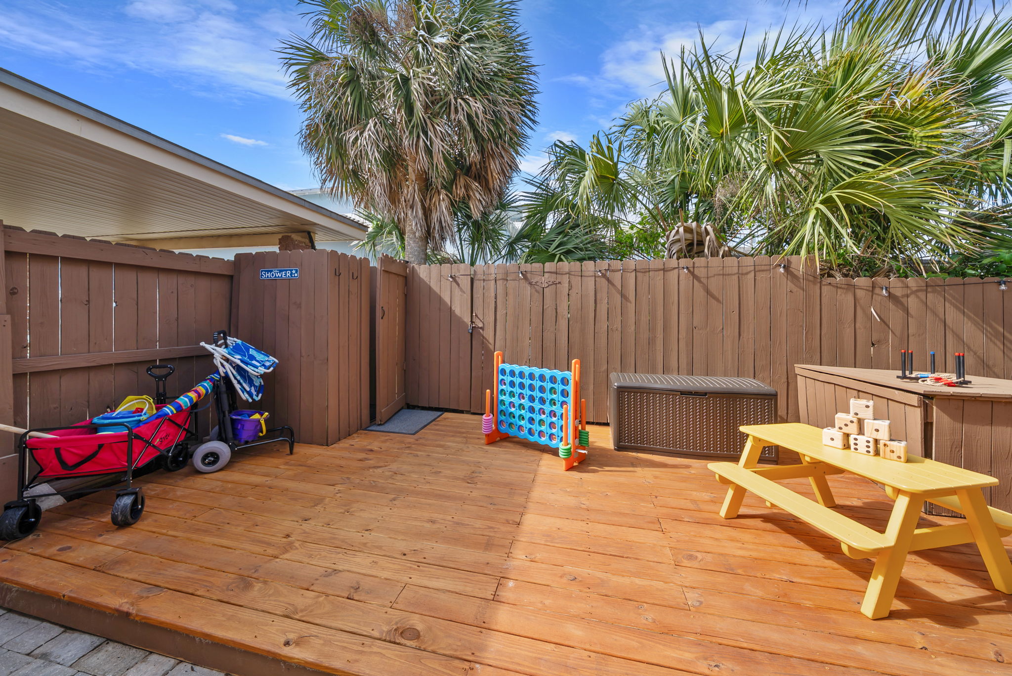 Challenge the kids to giant Connect Four, load the beach wagon with gear, and send the little ones to the yellow picnic table. The deck keeps everyone busy before the beach.