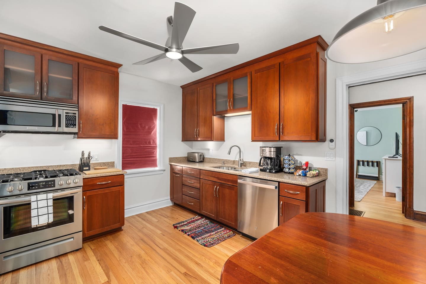 Kitchen with gas range, microwave, dishwasher, full kitchen utensils, plates, bowls, (kids cups and dishes), toaster, blender, waffle maker, and cookware.  Additional dining space for 4.