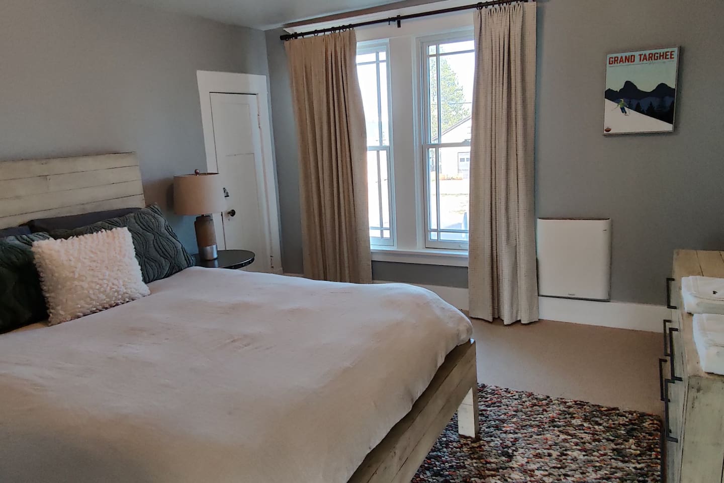Large second-floor bedroom with king-size mattress and updated bedding and furniture. 