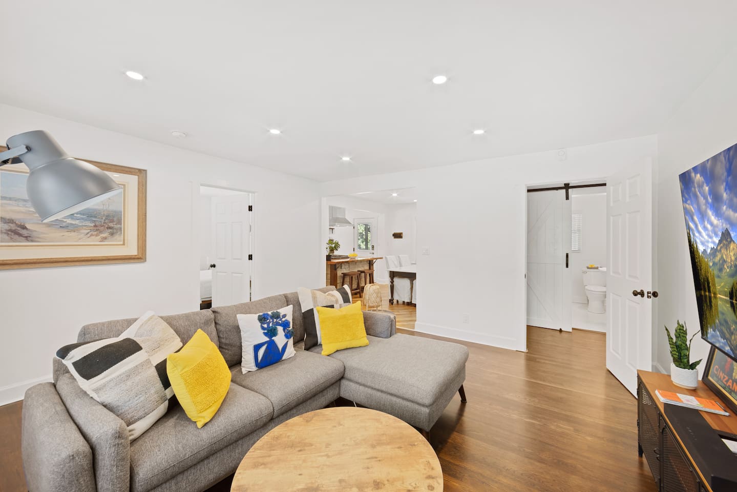 Open floor plan connects the living room with the dining and kitchen room. Clear view to the 70" smart TV from the kitchen, so you don't miss the game or your favorite show while cooking!