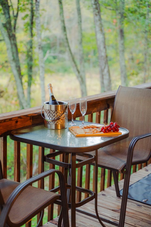 Enjoy a quiet moment at the outdoor dining table, surrounded by nature.