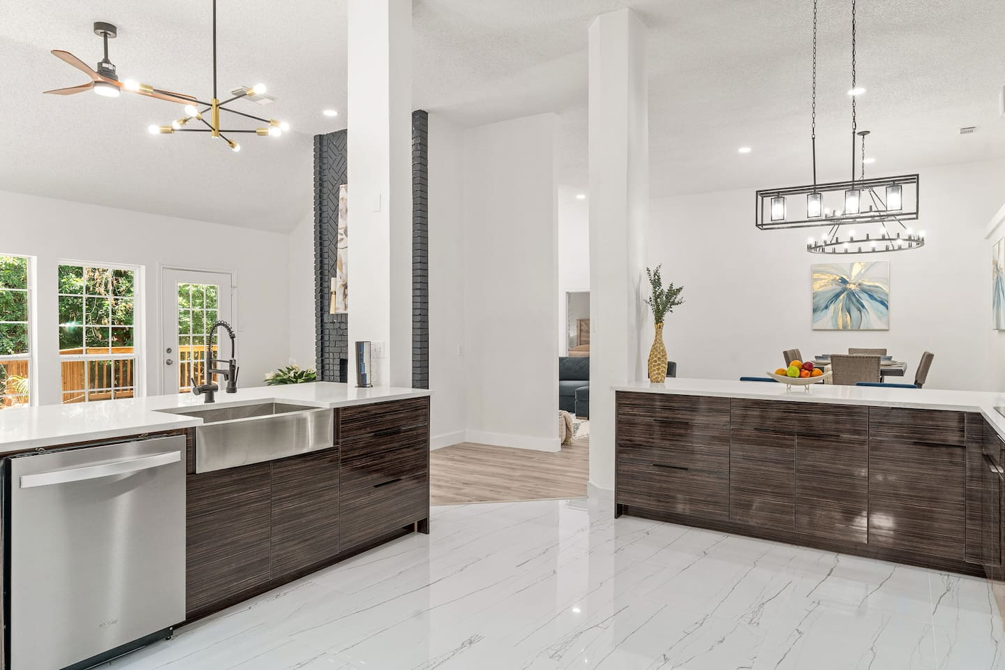 Sleek kitchen design perfect for preparing home-cooked meals featuring a deep sink, dish washer, and open concept kitchen into dining room.