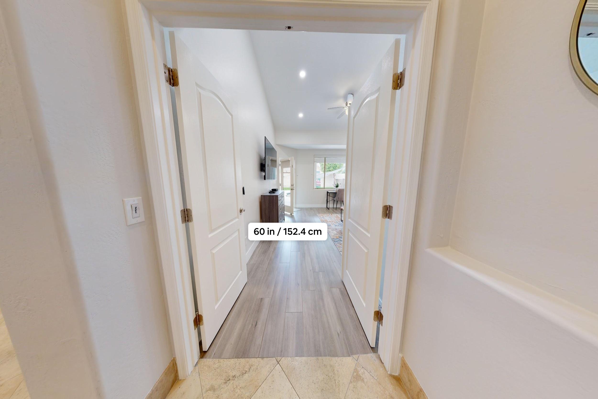 French doors with a 60 in opening leading into the primary bedroom.