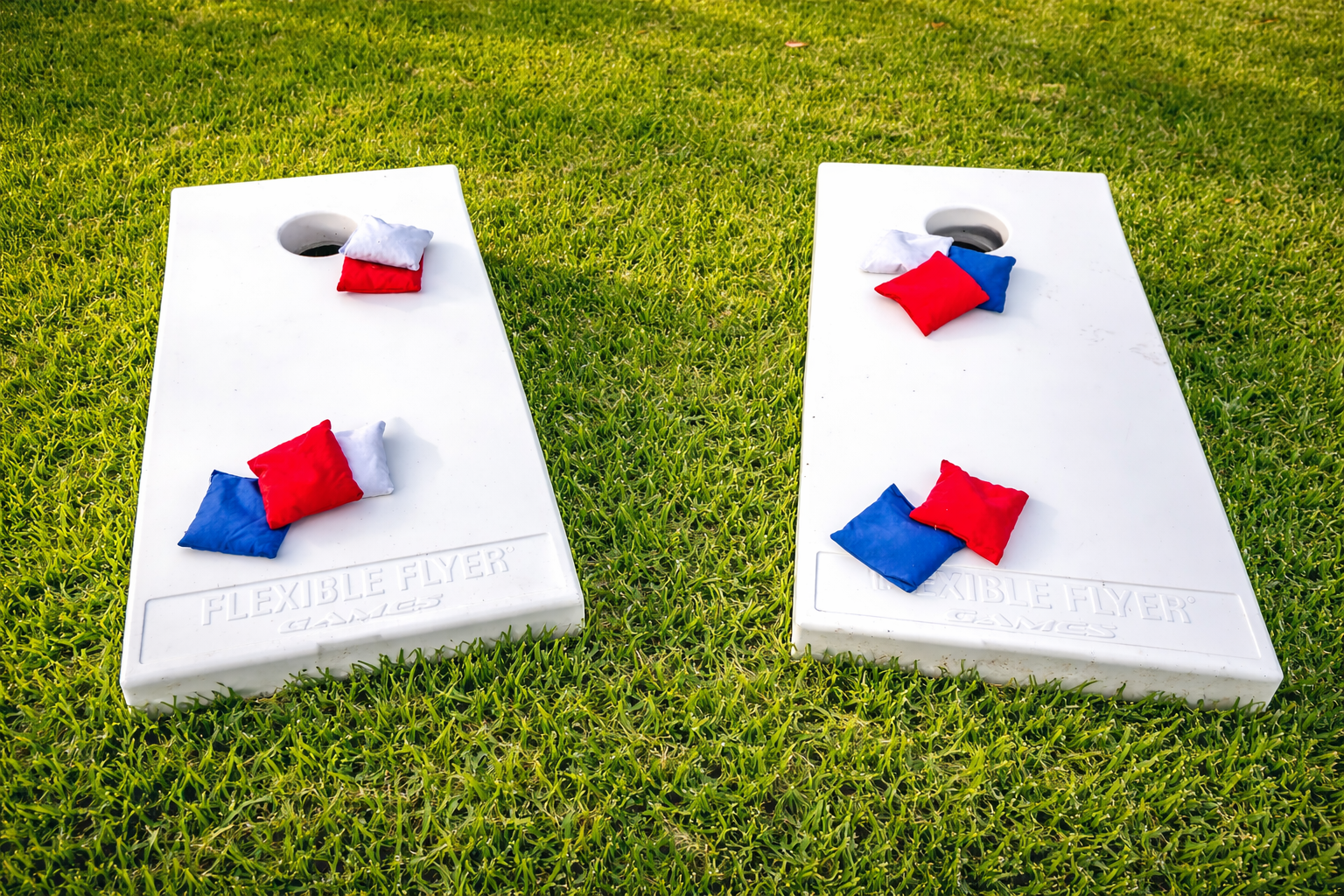 Spacious backyard with cornhole, lawn games, and open green space for kids and group activities.