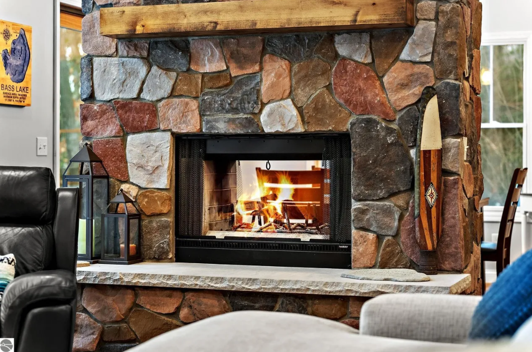 Enjoy the double-sided fireplace in the center of the open concept kitchen, dining and living room.  