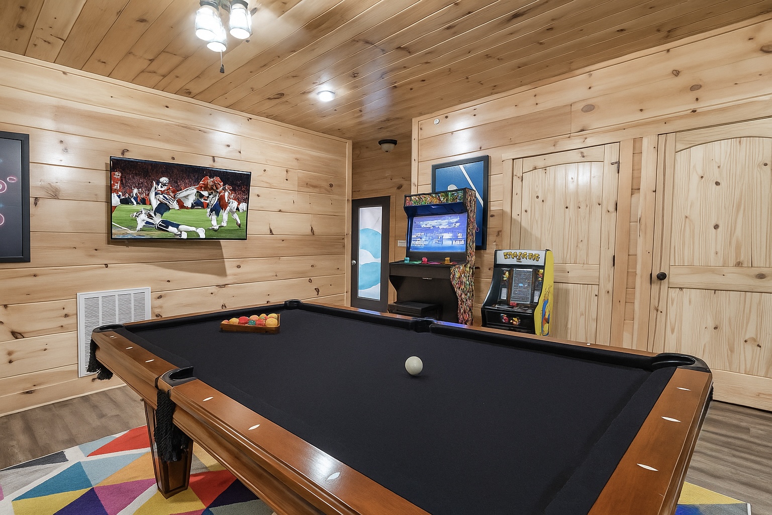 The game room also includes a pool table, 2 arcade games, and a TV
