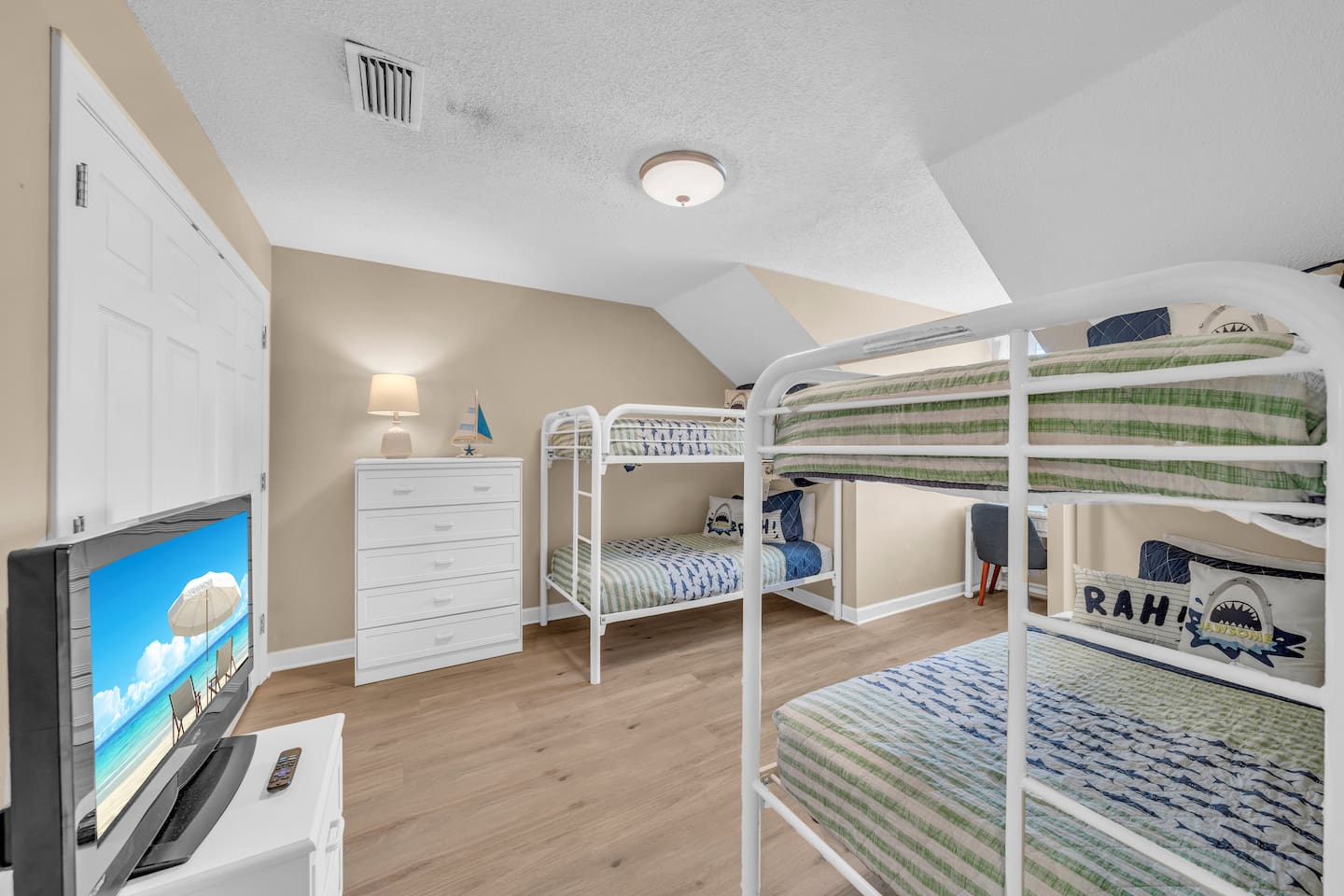 East upstairs bunk room.  Two sets of twin over twin bunkbeds, tv