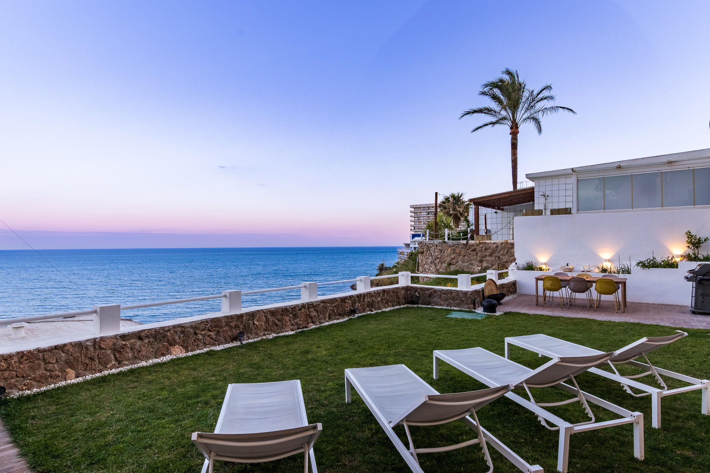 Sunset atmosphere over the private garden and loungers