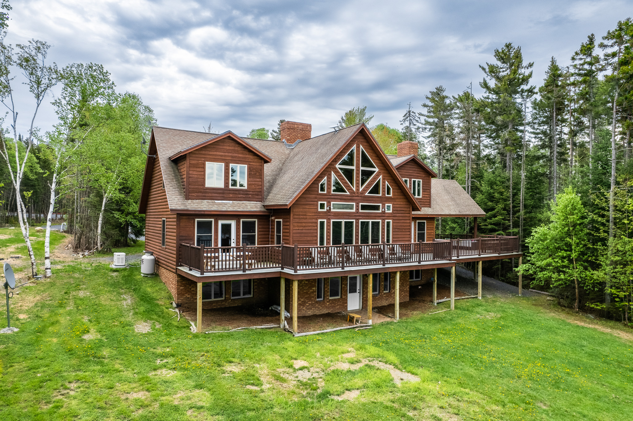 Escape to the back yard overlooking beautiful Lily Bay with amazing sunsets. Play a game of corn hole, gather by a crackling fire with 2 fire pits, or lounge by the your private dock and read a book. An enjoyable spot for everyone to hang out.