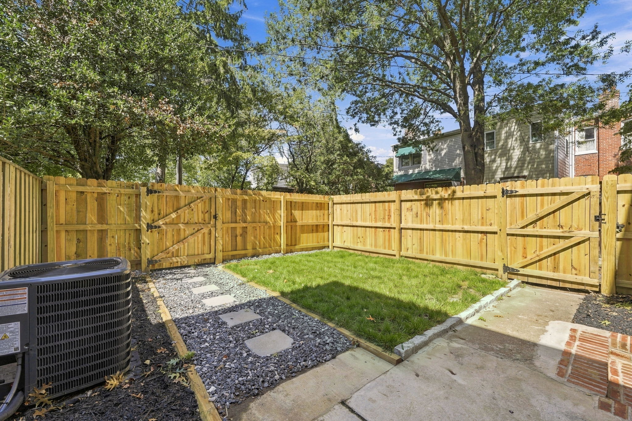 Private Oasis: Enjoy sunny afternoons in your fenced yard, complete with lush grass and a cozy path!