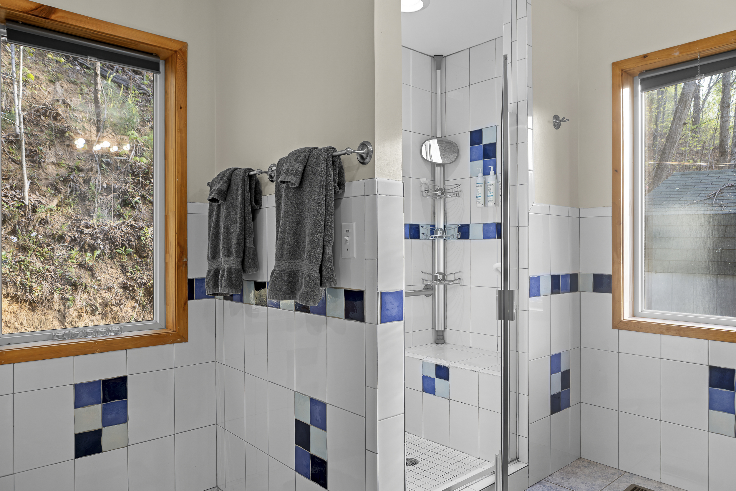 Master Bathroom 1: Bright tiles and natural light create a refreshing washroom experience!