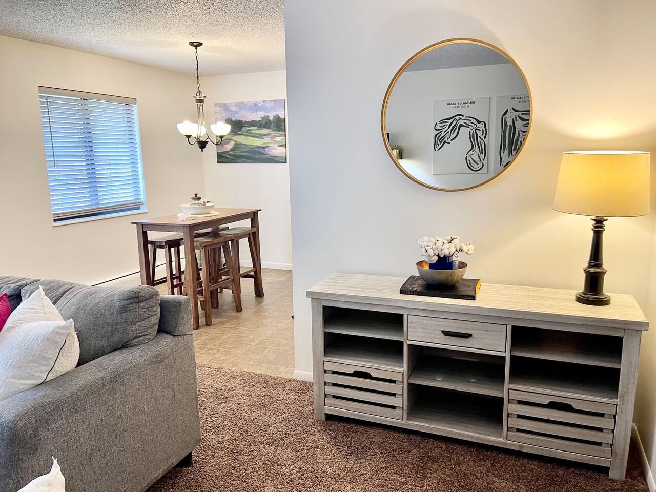 This charming space features a cozy dining nook and stylish console area with warm lighting and tasteful decor. Ideal for enjoying quiet meals or evening conversations, it blends comfort and functionality in a welcoming home-away-from-home atmosphere