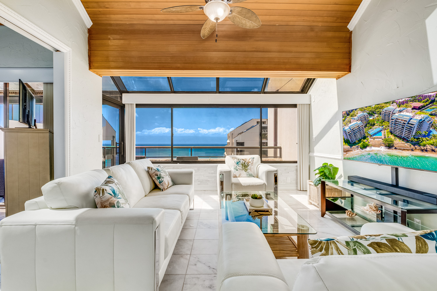 Large living area with sleek modern furniture, Smart TV and plenty of tropical sunlight and blue sea!