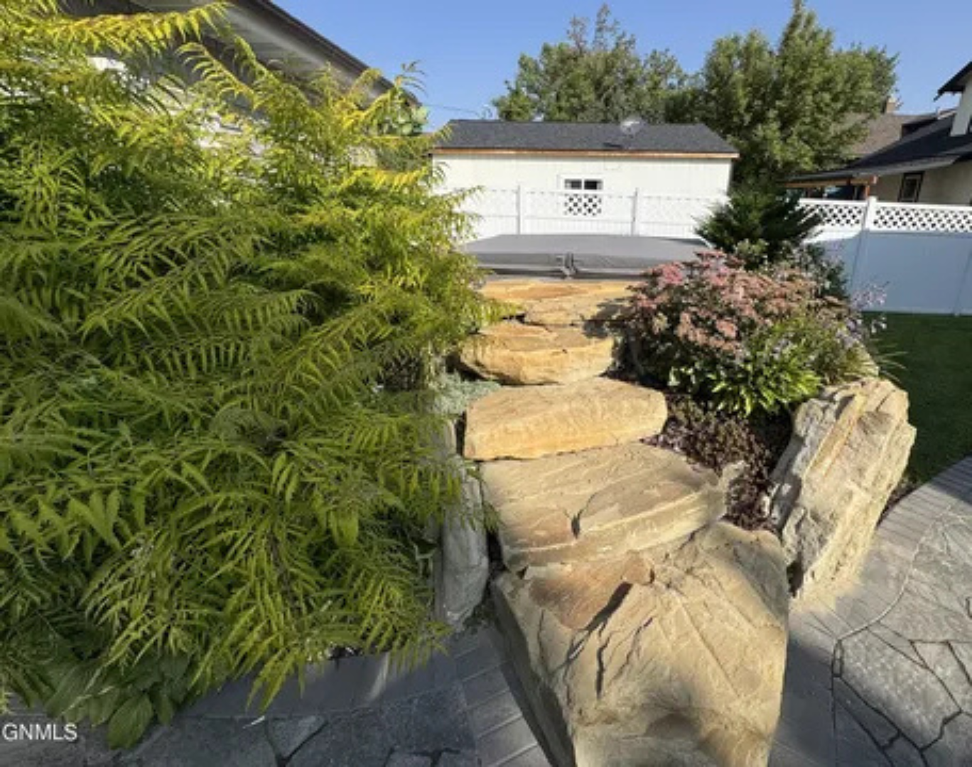 This outdoor path adds so much charm with its greenery, stonework, and garden feel.