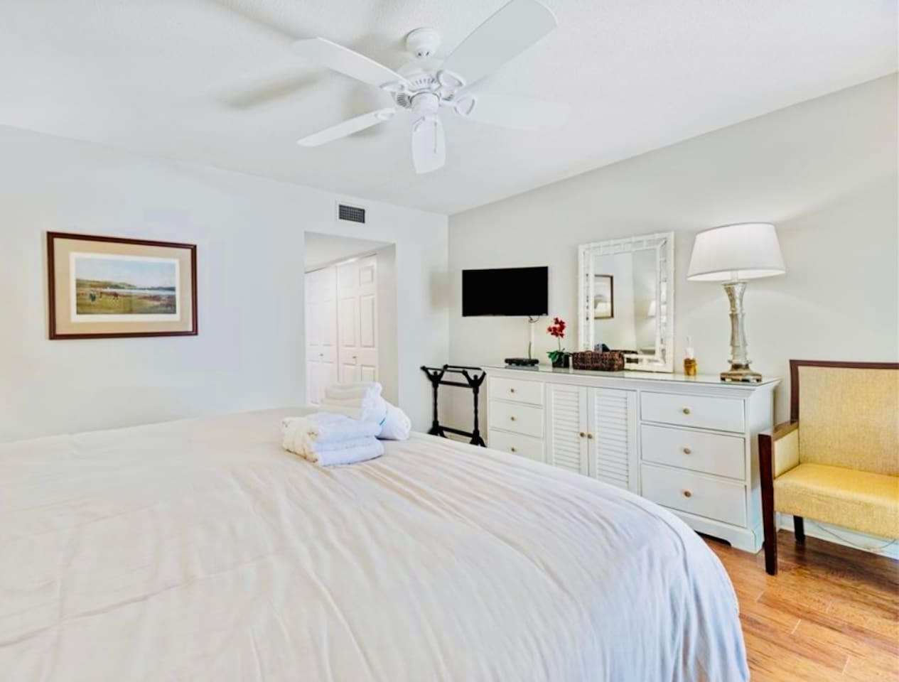 Primary bedroom with dresser and Smart TV