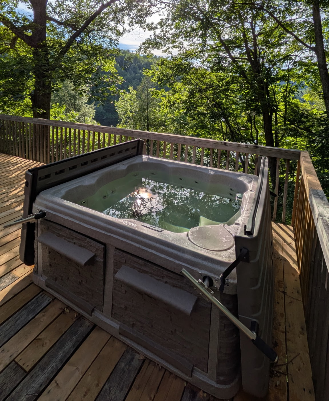 Hot tub with view of Lac McArthur from cottage balcony