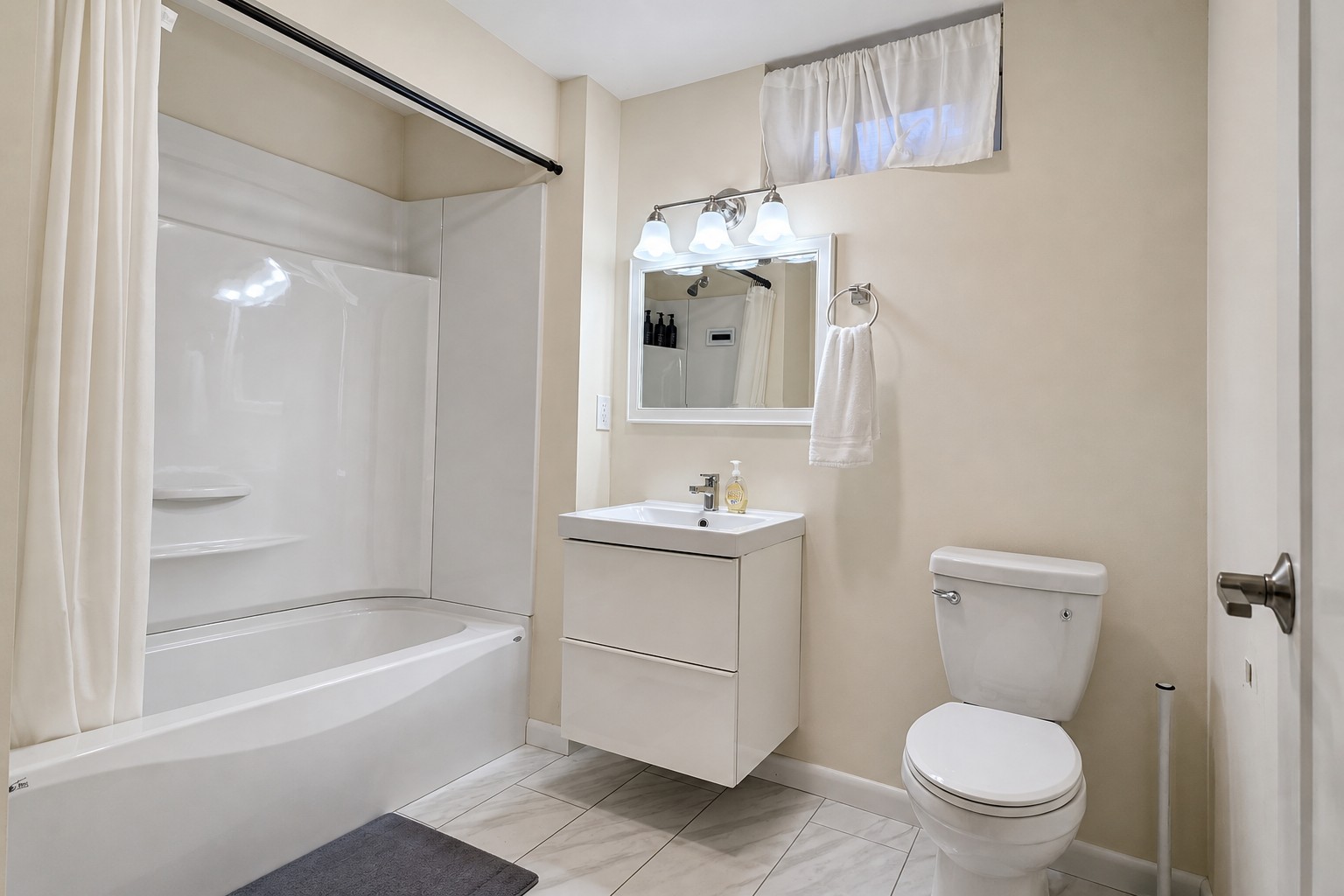Lower-level full bathroom with tub and shower