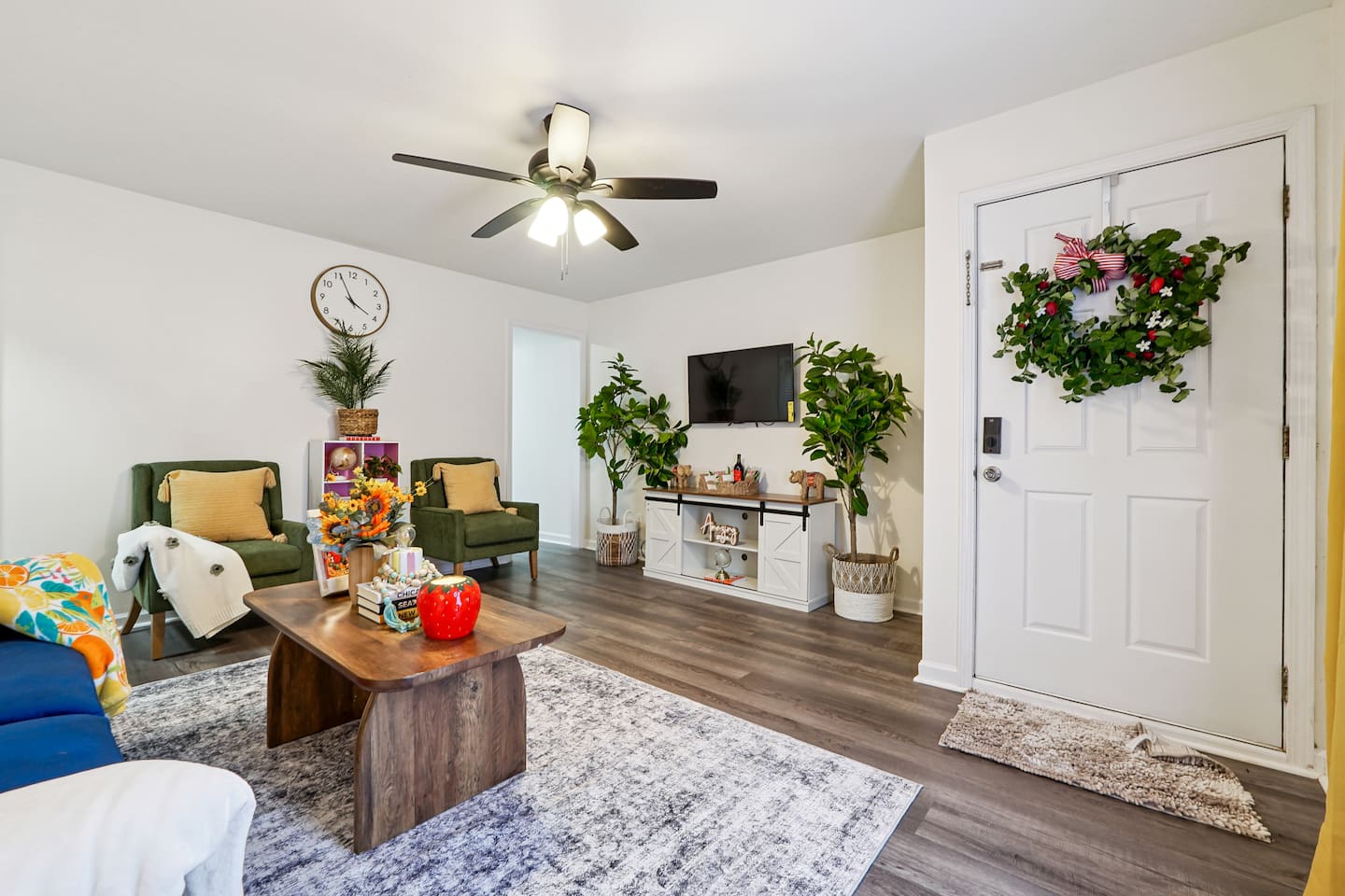The living room features cozy furniture, including a comfortable blue couch, and an Amazon Fire-powered Smart TV for your entertainment. You’ll also find the Xfinity modem conveniently located here, convenient for ethernet connection.