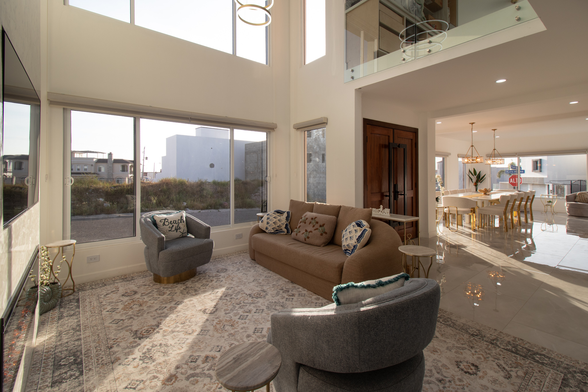 Soaring two-story great room with floor-to-ceiling windows & plenty of space to gather