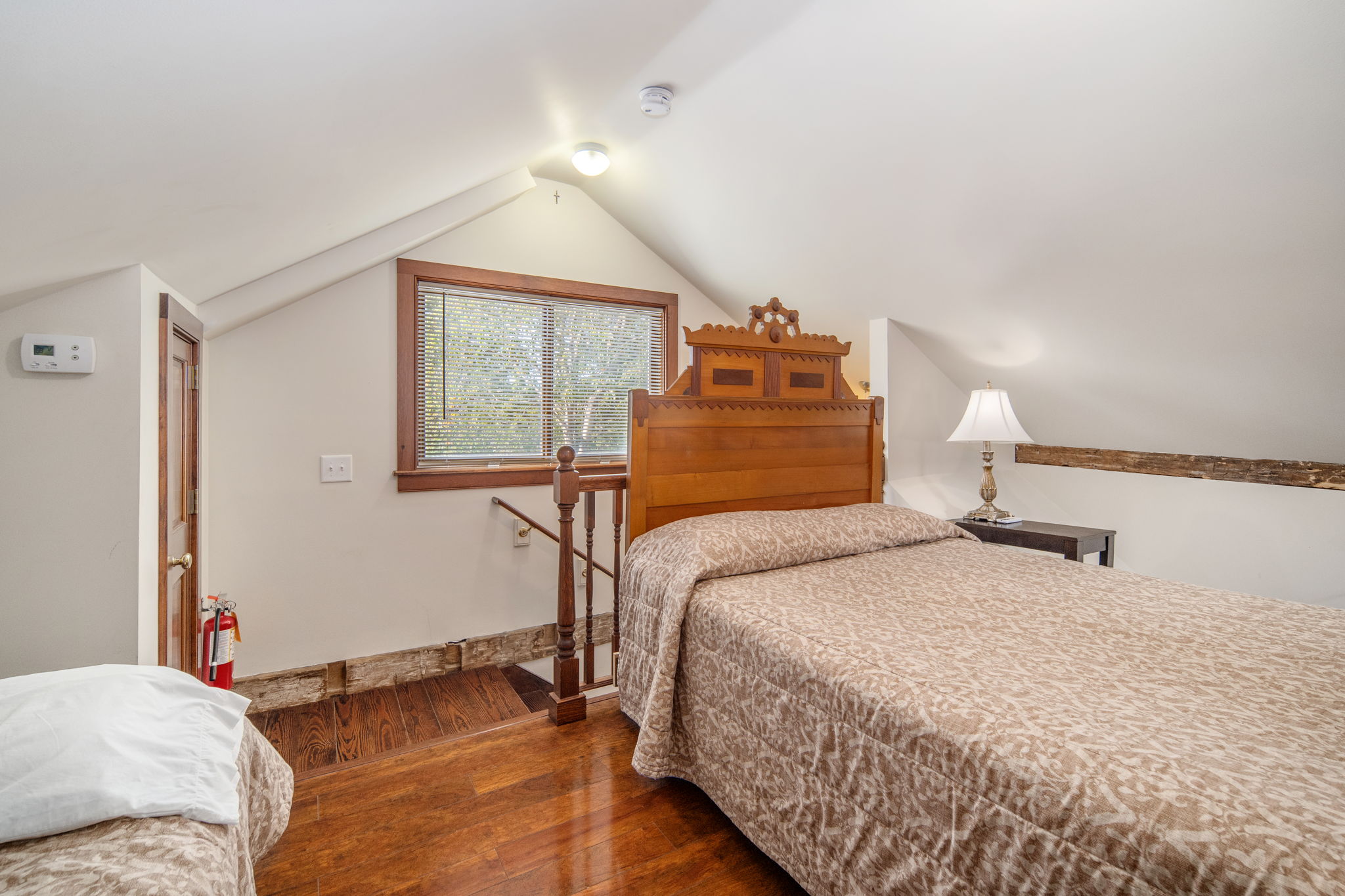 A charming upstairs bedroom tucked beneath the barn's sloping ceiling.
