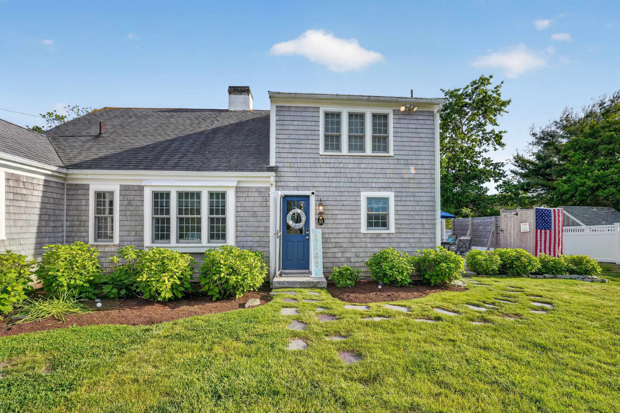 Charming Cape-style home with beautifully landscaped grounds, welcoming curb appeal, and ample parking.