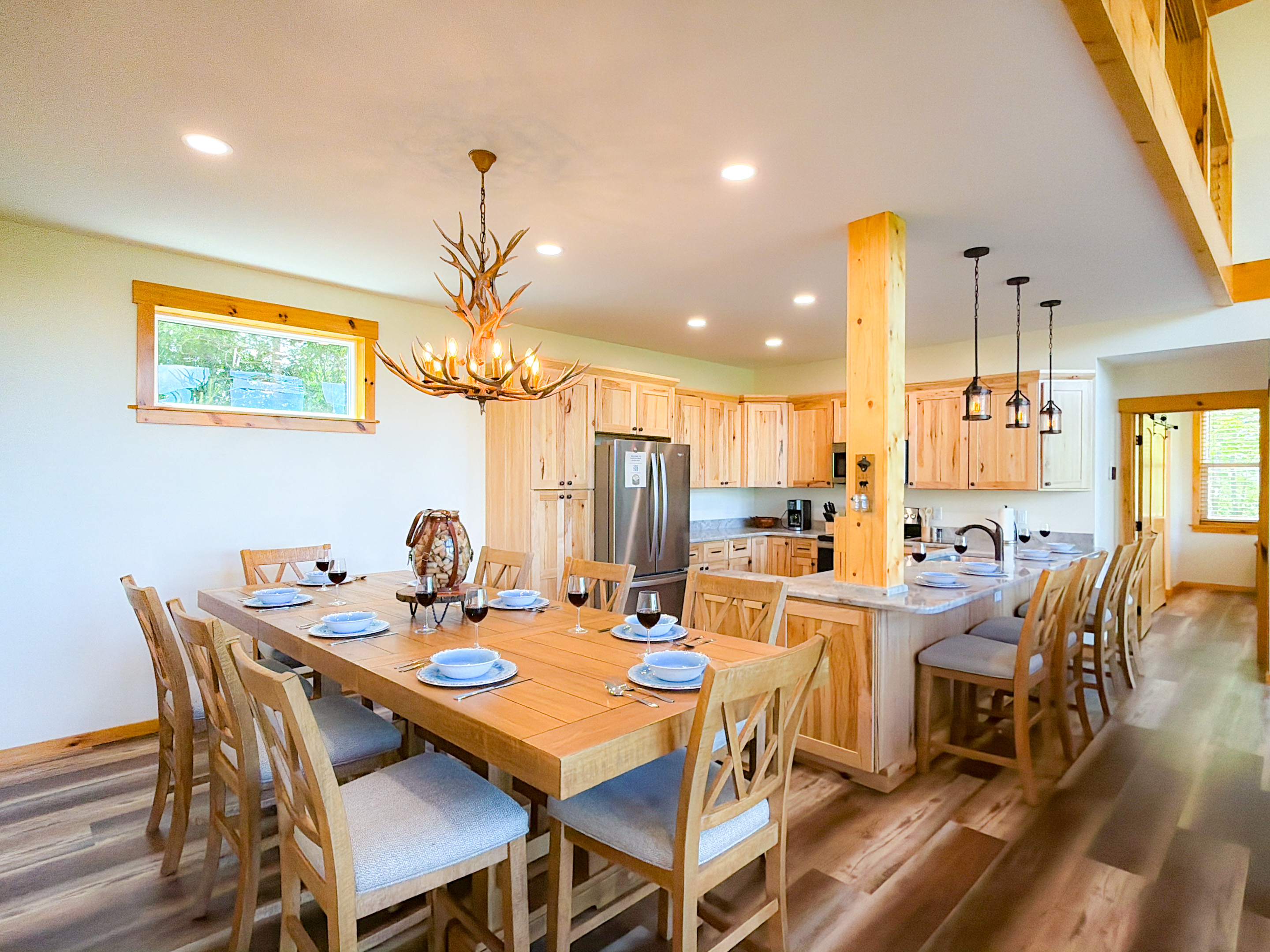 Large dining table for up to 8 persons. Additional Seating at the bar top.