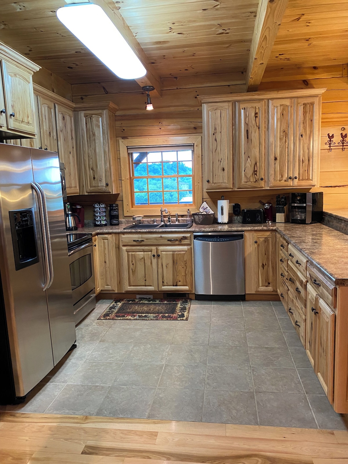 The kitchen has high-quality appliances (refrigerator/freezer, range, microwave, dishwasher, 2 coffee makers (Keurig,Drip), high-quality Hickory cabinets, lots of cabinet space (supplemented with more cabinets in the dining area) and a window to the lake. 
