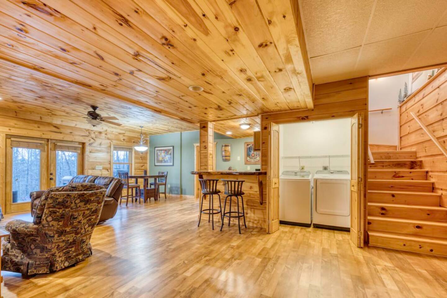 The washer and dryer are conveniently placed within the game room for easy access.