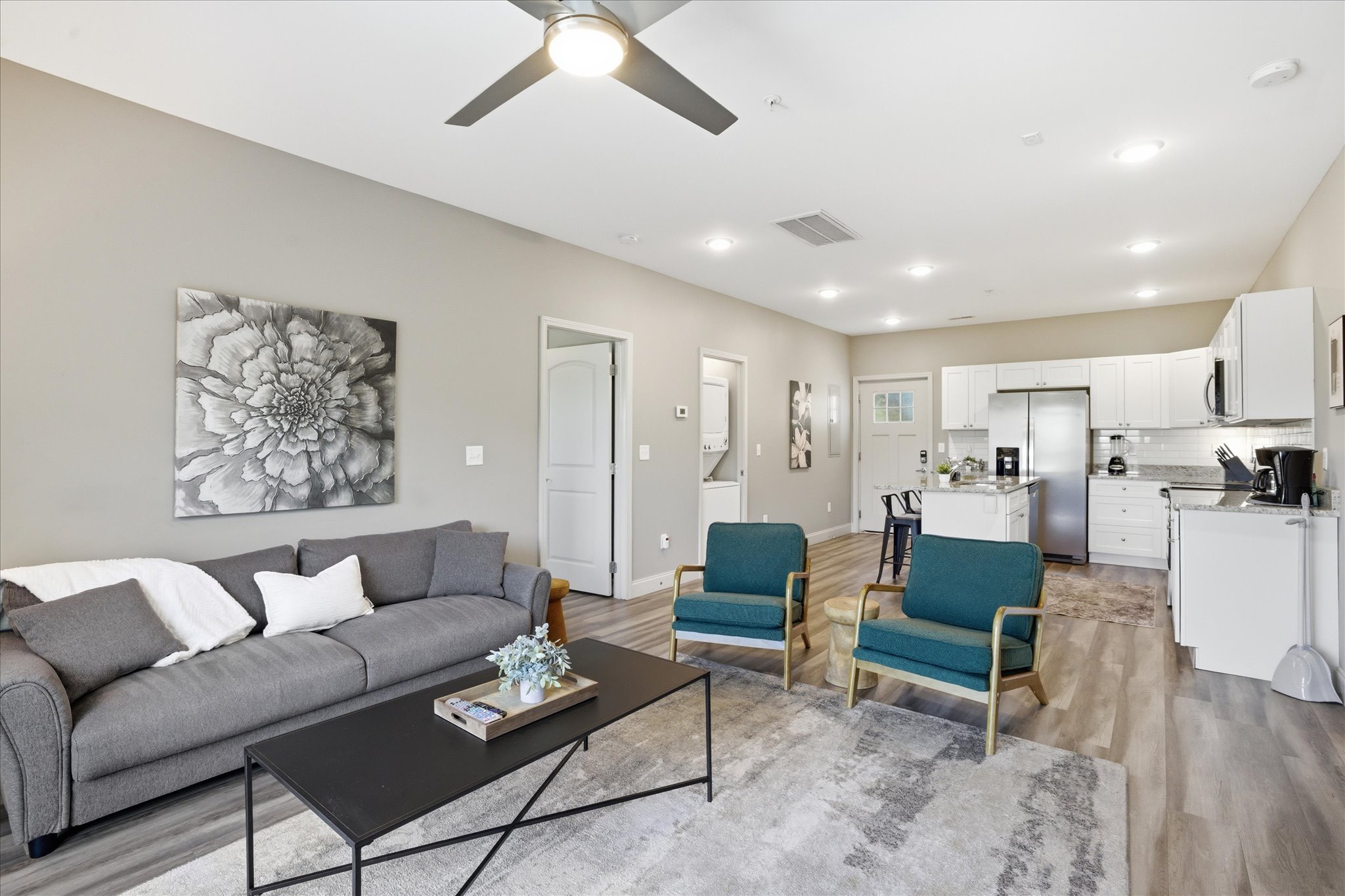 From this angle in Unit 1, you can see how it all connects—kitchen, seating, and a space that keeps everyone in the mix, whether you’re watching something or just hanging out.