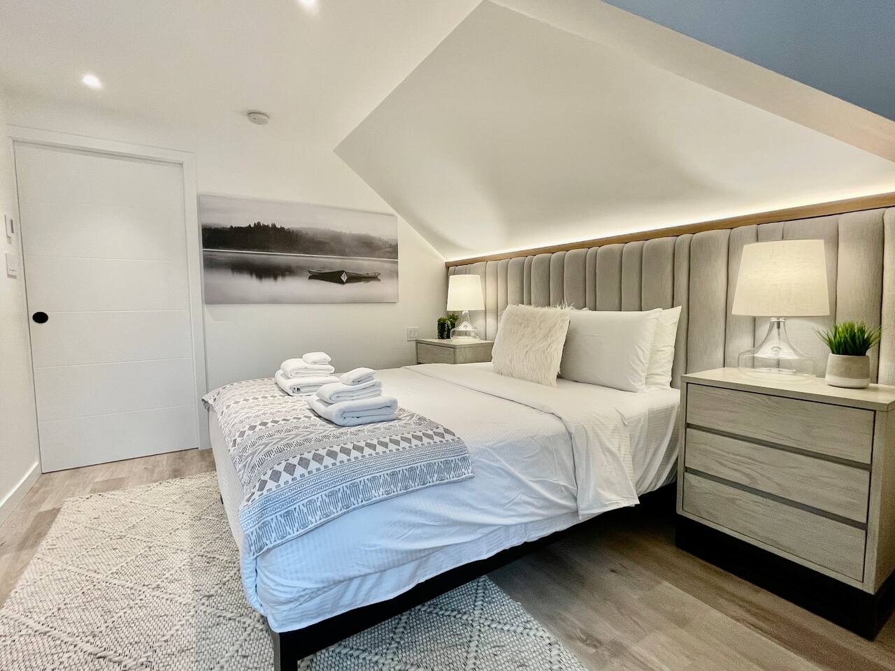 Master bedroom #1 features built in wall to wall upholstered headboard with built-in accent lights 