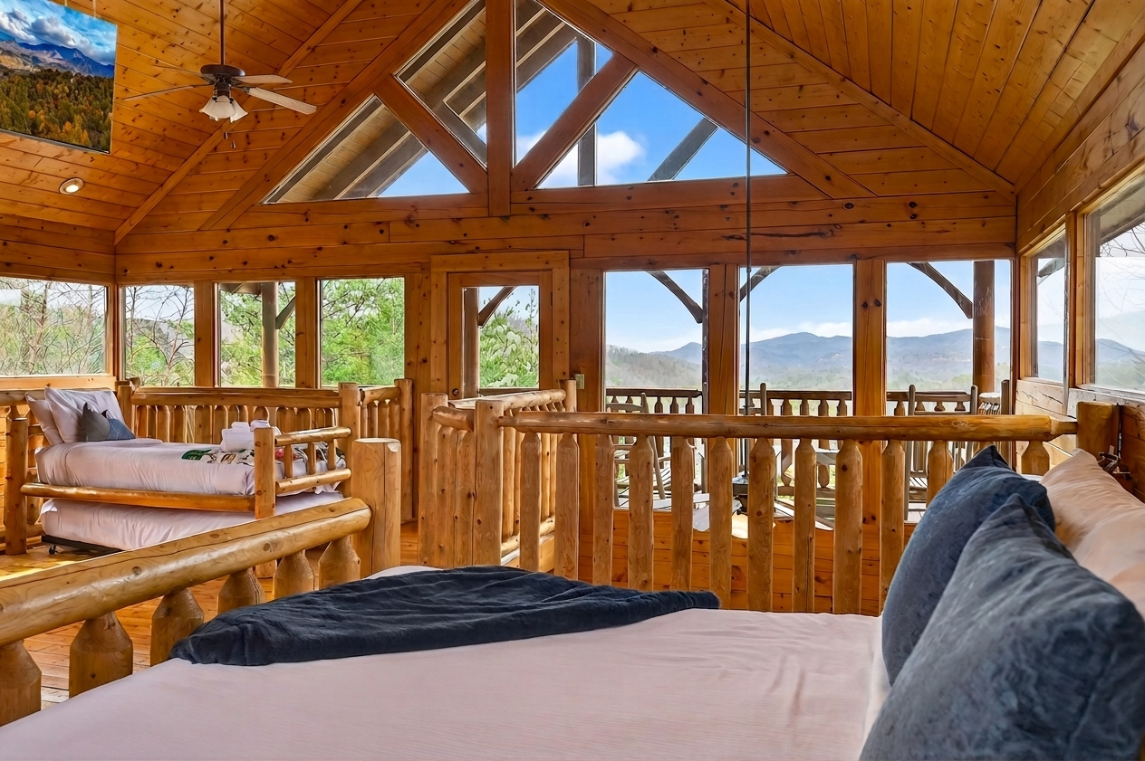 Wake up to the Smokies — floor-to-peak windows frame the mountains from your bed.