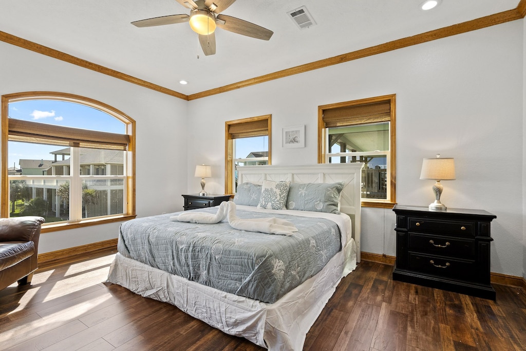 Primary bedroom with king sized bed and private en-suite bathrooms.