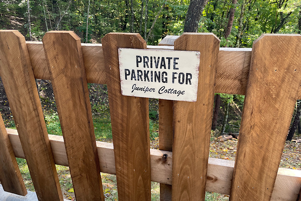 Parking for Juniper Cottage sign beside cabin