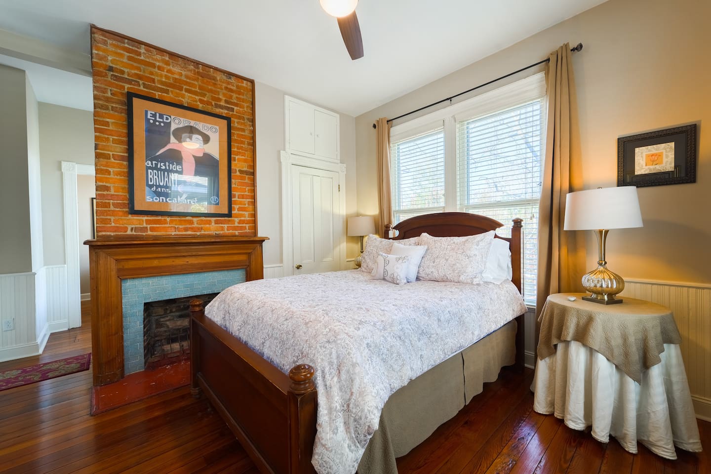 Primary Bed with a luxury mattress and new linens. Brick non-working fireplace with historical touches. 