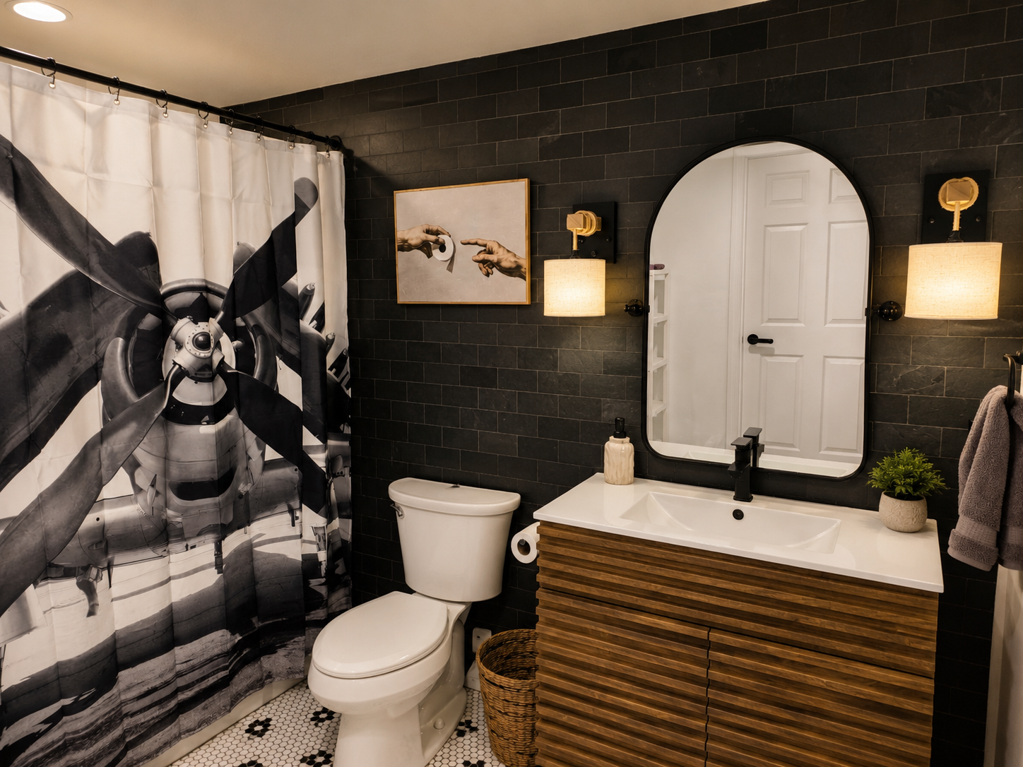 Private basement bathroom with a walk-in shower, modern vanity and bold aviation-inspired wall art.