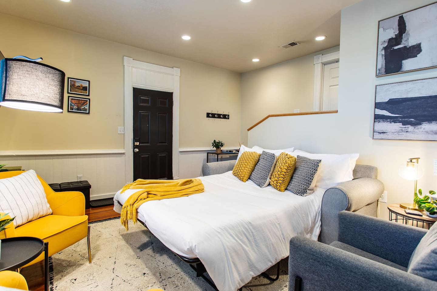 Living area featuring a comfortable couch, a stylish center table, and tasteful wall décor, creating a cozy and aesthetically pleasing space to relax and unwind.
