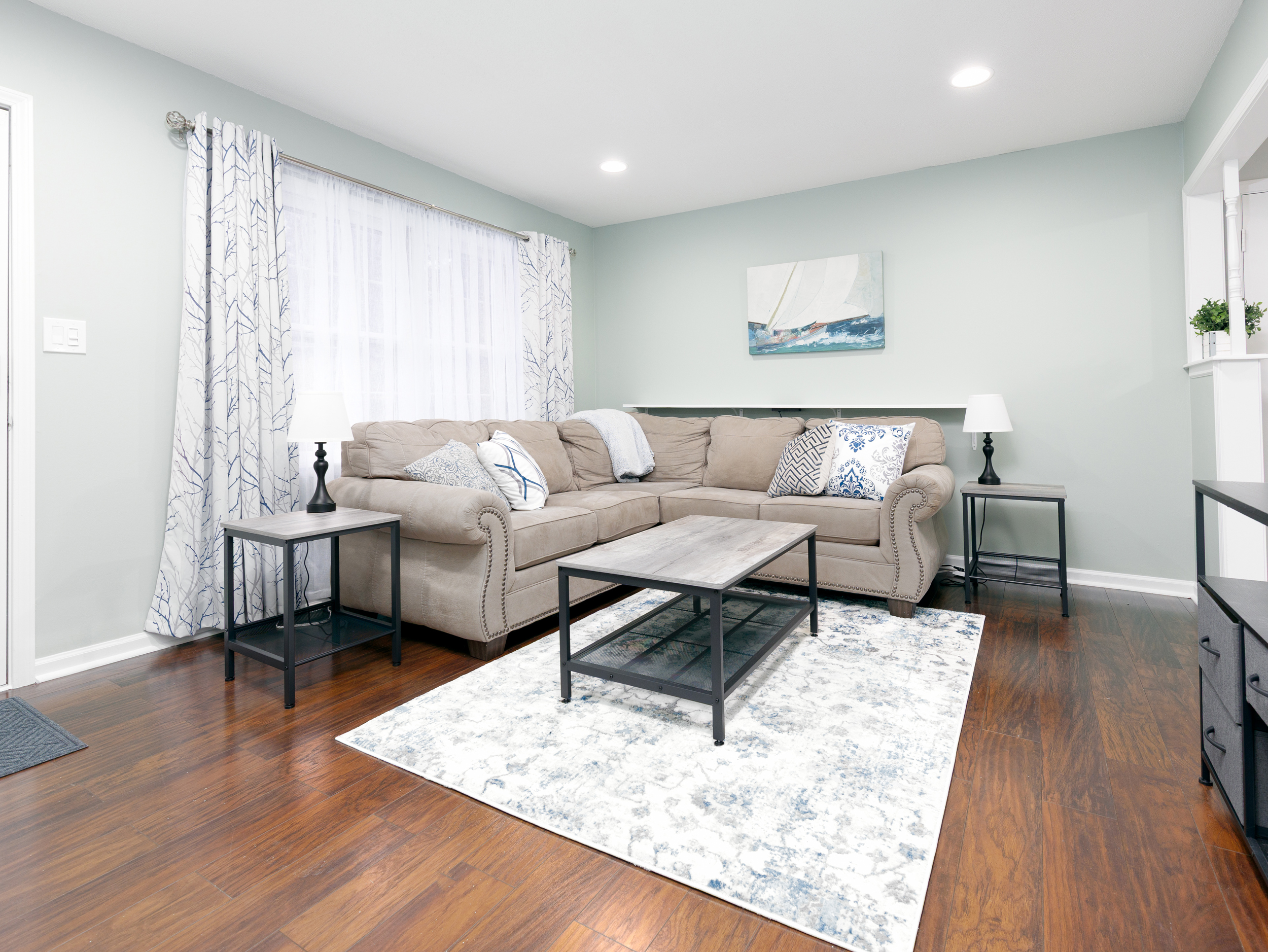Living room seating area with comfortable furnishings and natural light.