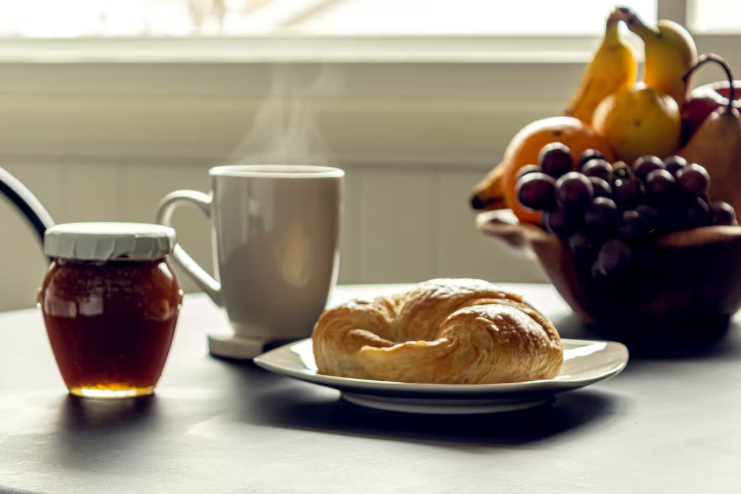 Fresh fruit, warm pastry, and coffee steaming by the window — breakfast doesn't get more inviting.