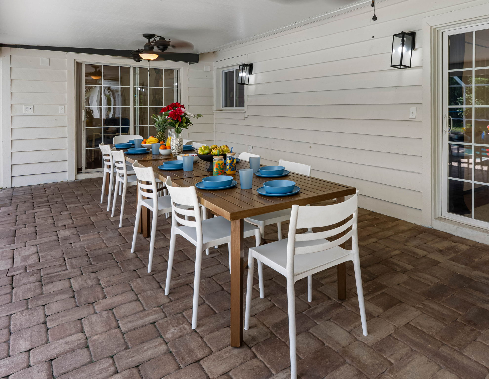 Featuring an extended dining space and poolside seating, this screened enclosure is perfect for both quiet mornings and lively evenings.