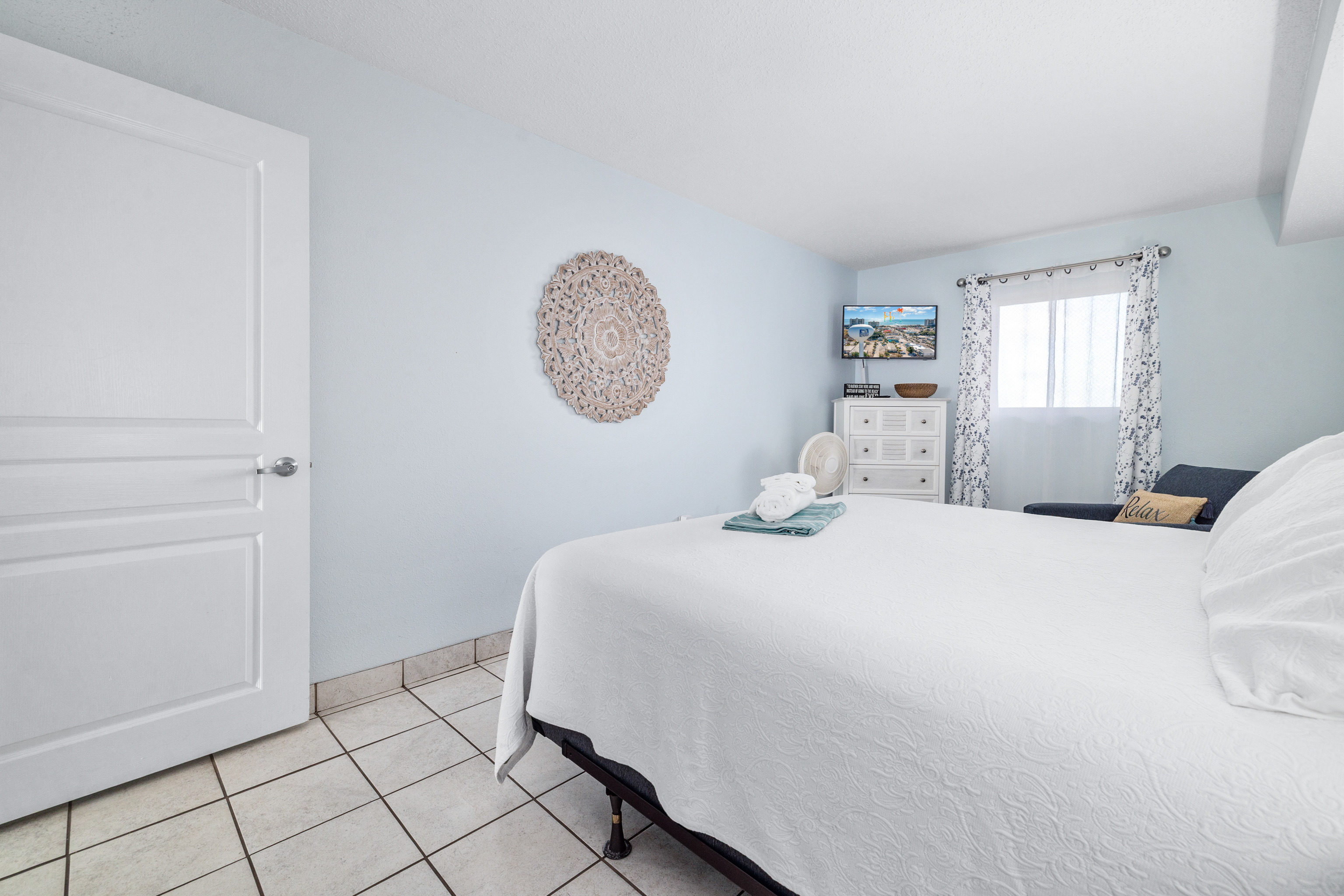 Soft linens, fresh design create a peaceful place to rest. A kitchen between bedroom and main living space provides privacy and minor separation of the spaces