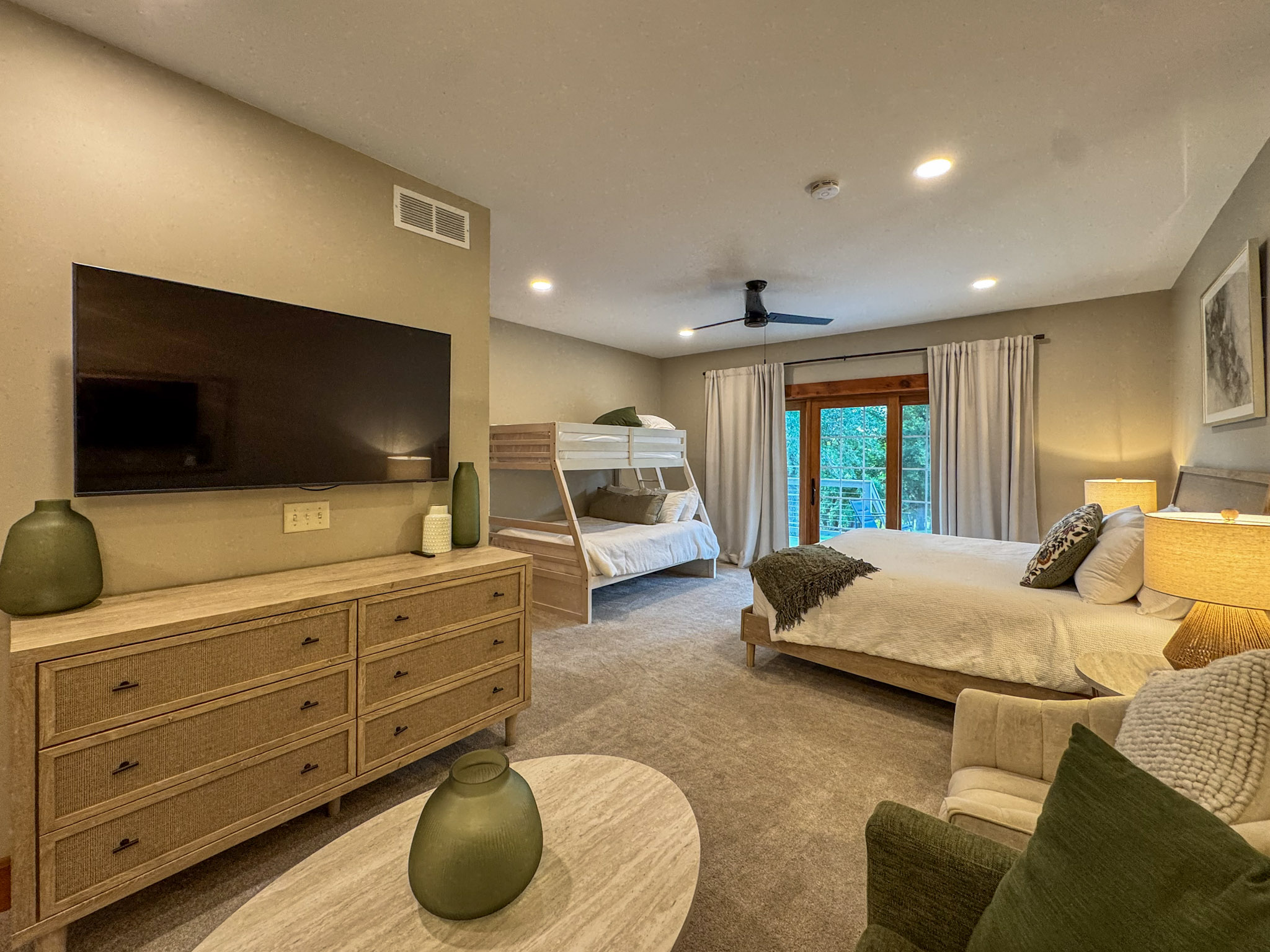 One of our two Jack and Jill bedrooms, each with a king bed and a queen-and-twin bunk bed. The two rooms have matching, mirrored layouts.