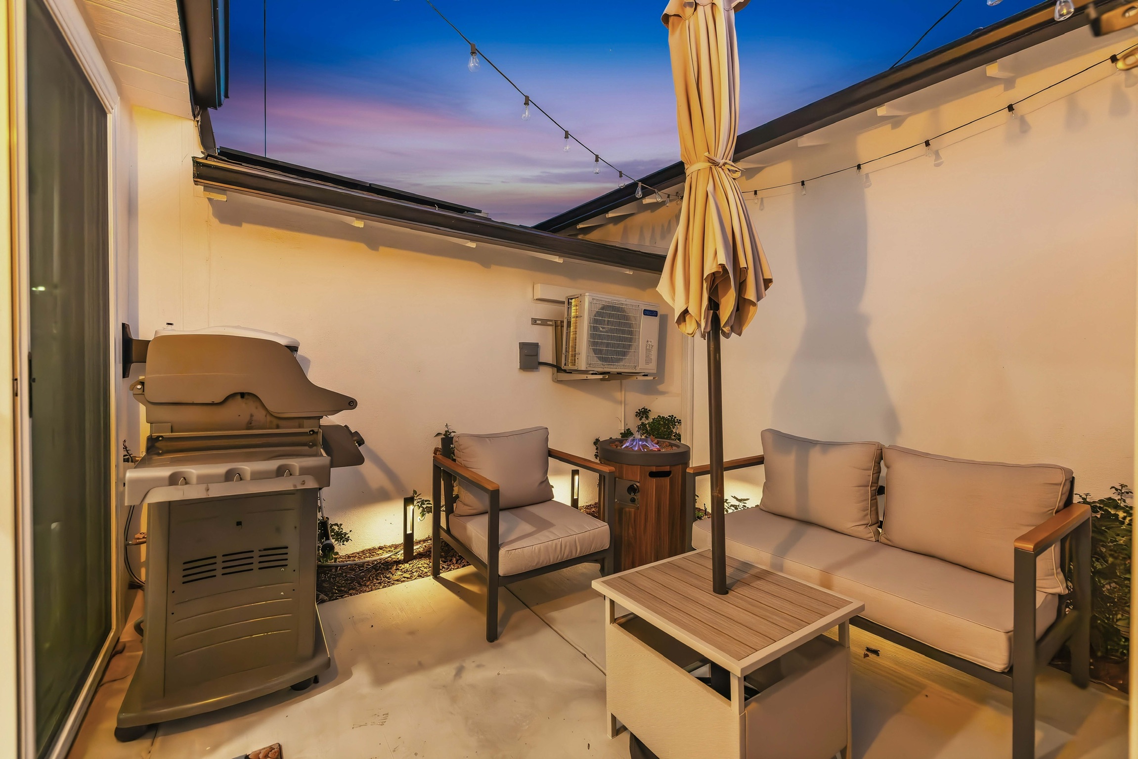 Side patio with bbq, seating and fire table