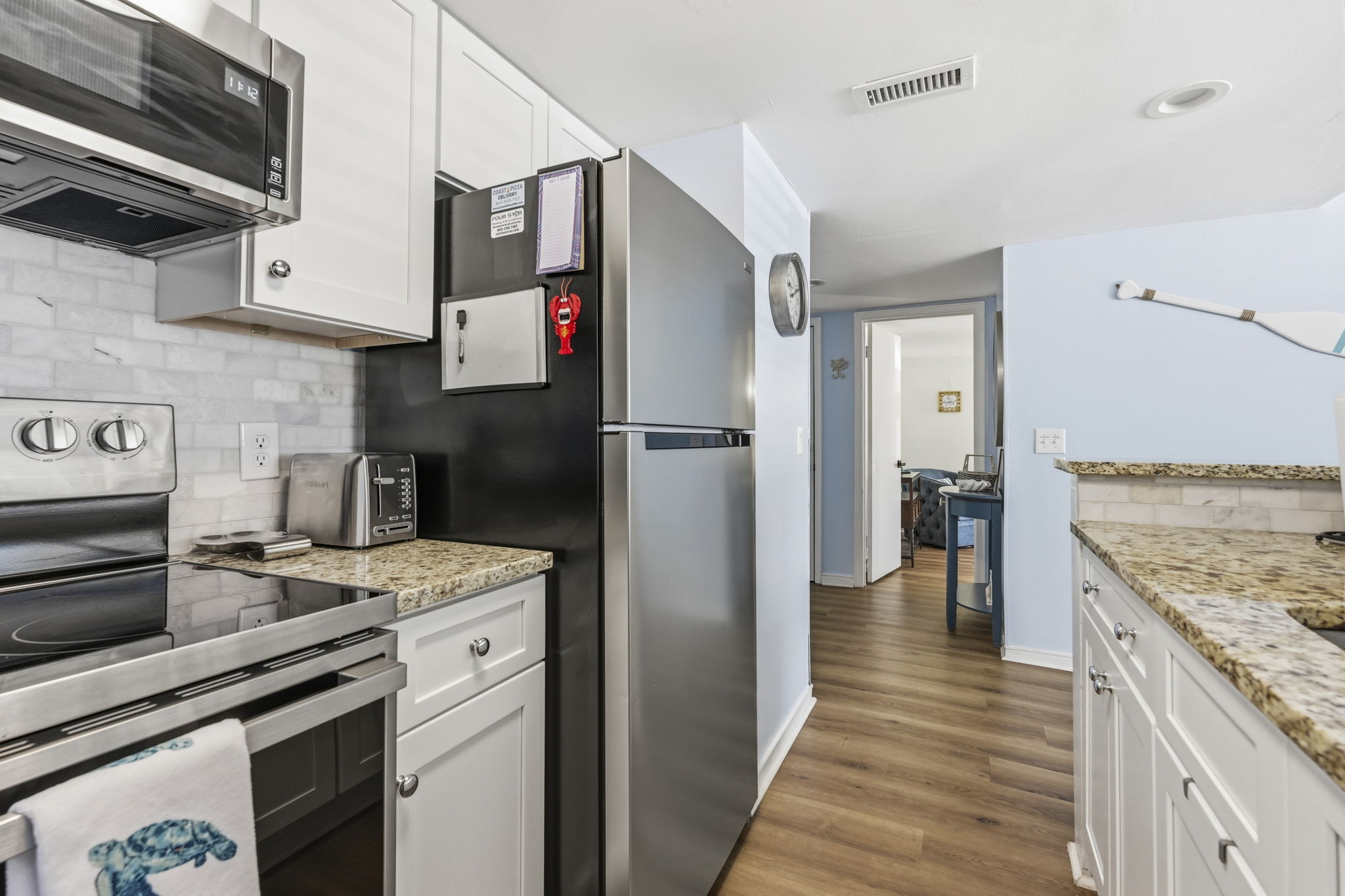 Full kitchen with stainless steel appliances and granite countertops